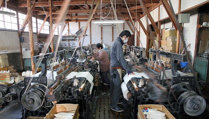 Workers in Japanese waist apron maker Anything