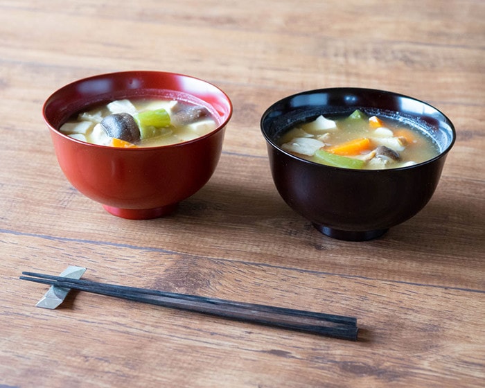 Red and black lacquer bowls with miso soup