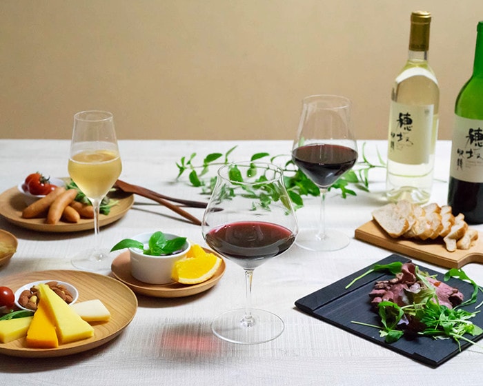 Wine glasses with cheese or fruits on the table